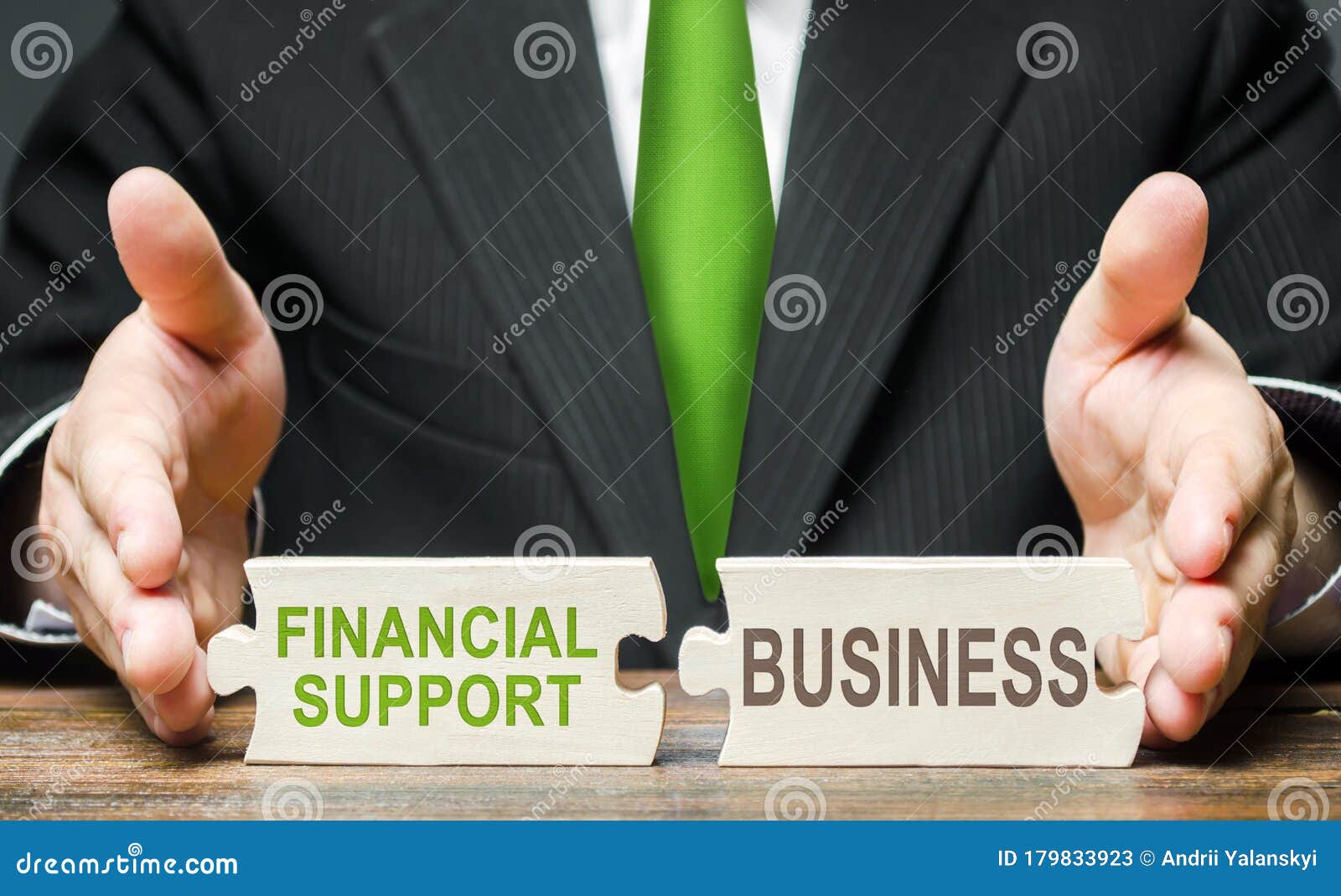 man connects two puzzles providing financial support to business in a crisis situation. government assistance in overcoming the