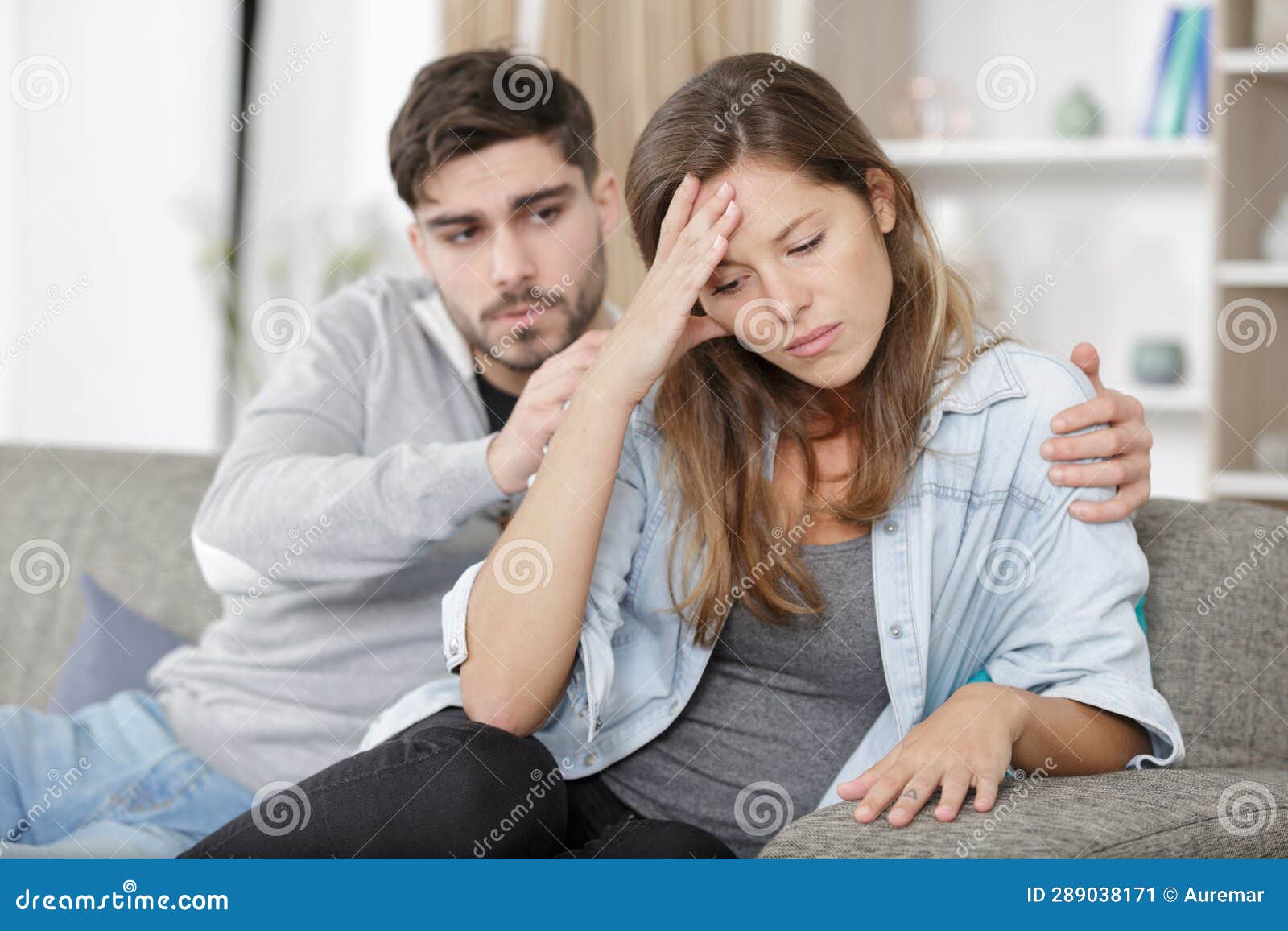 man consoling upset woman