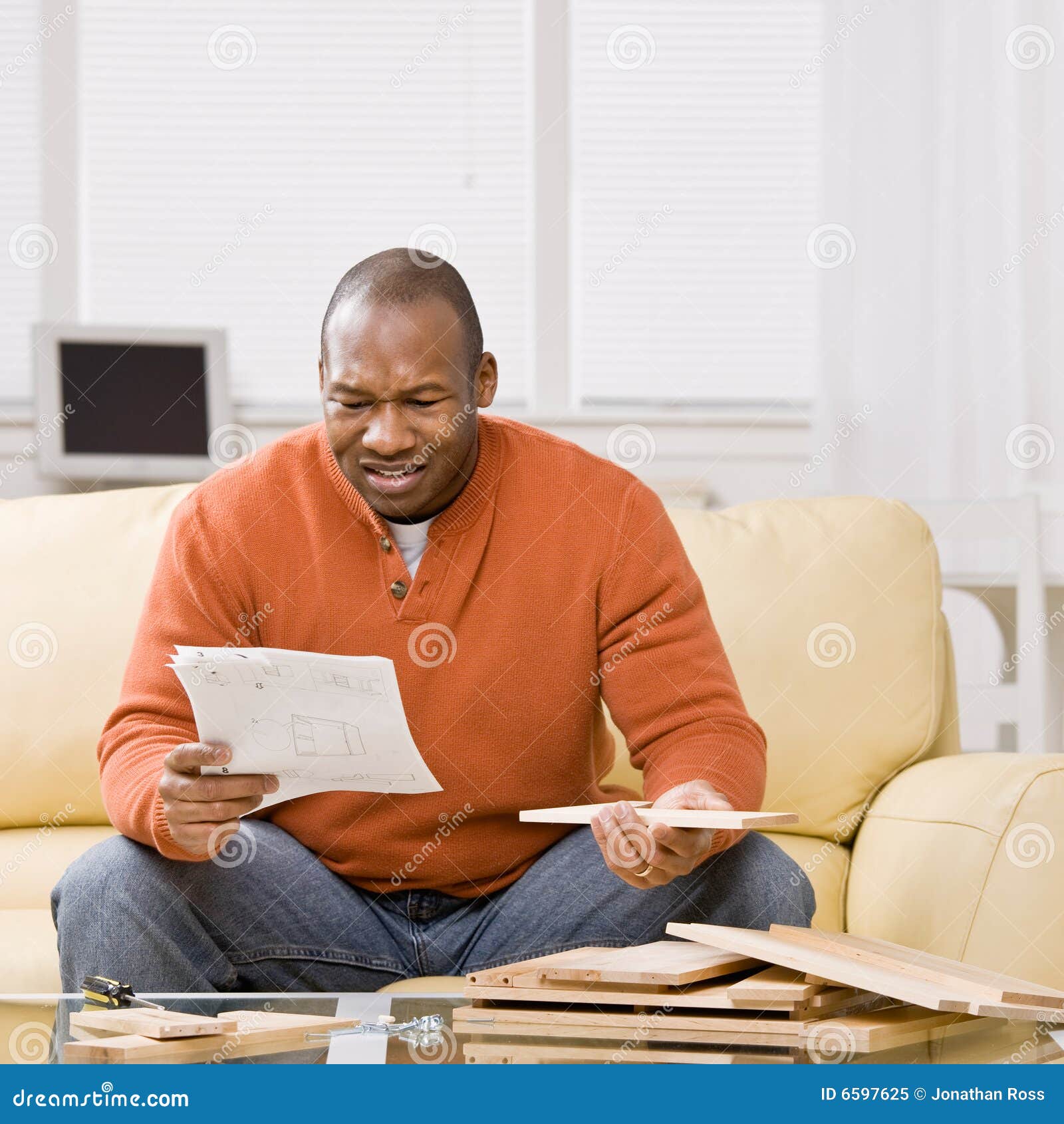 man constructing wooden shelf