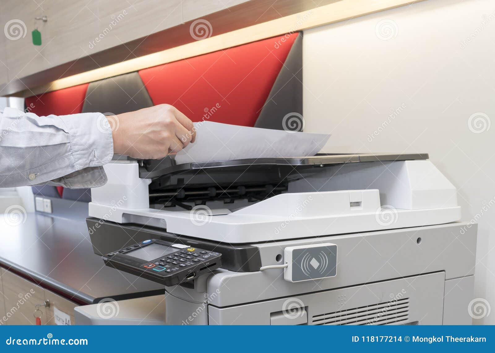 man copying paper from photocopier with access control for key card scanning
