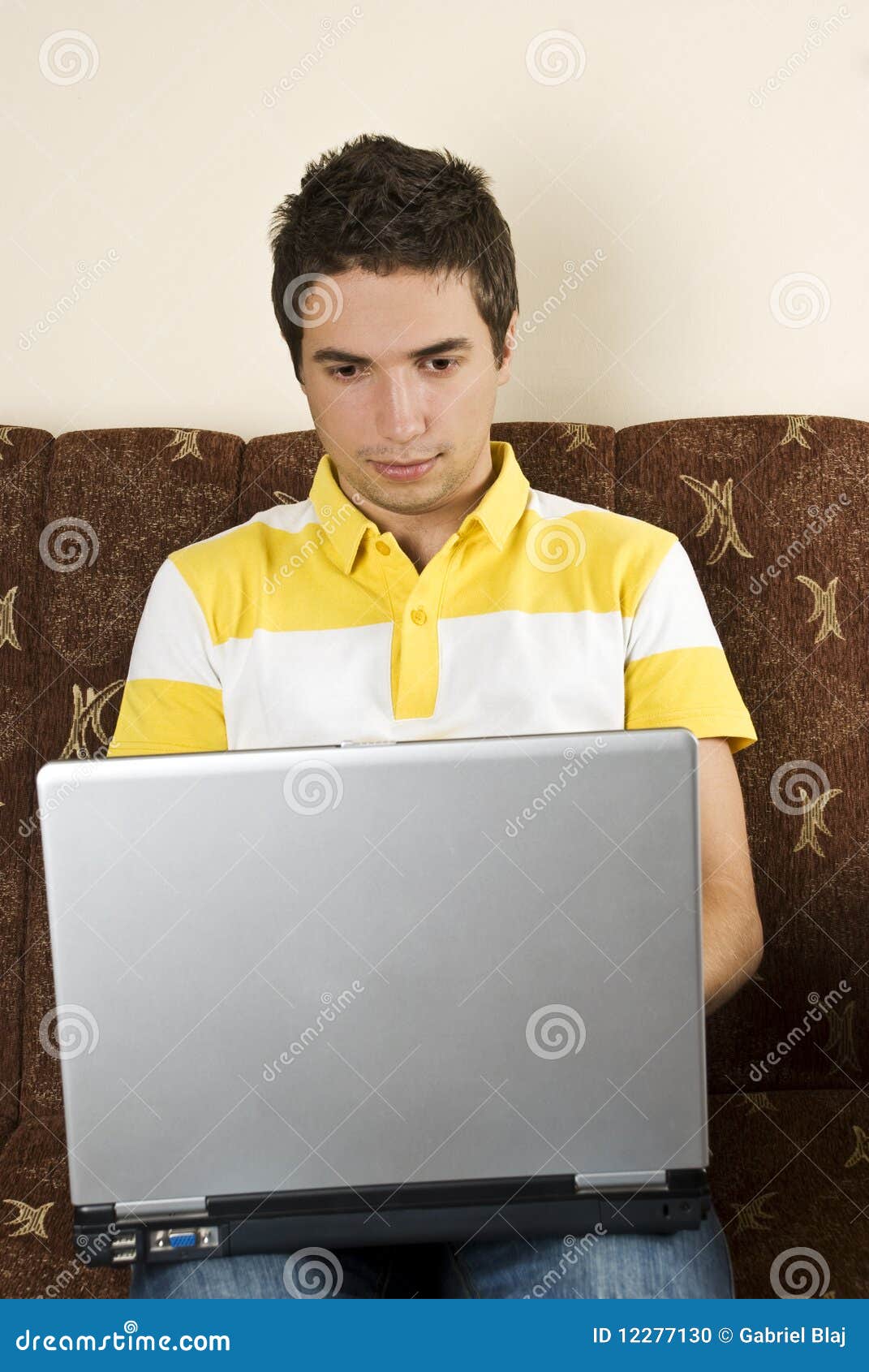 Man in couch with laptop stock photo. Image of 12277130