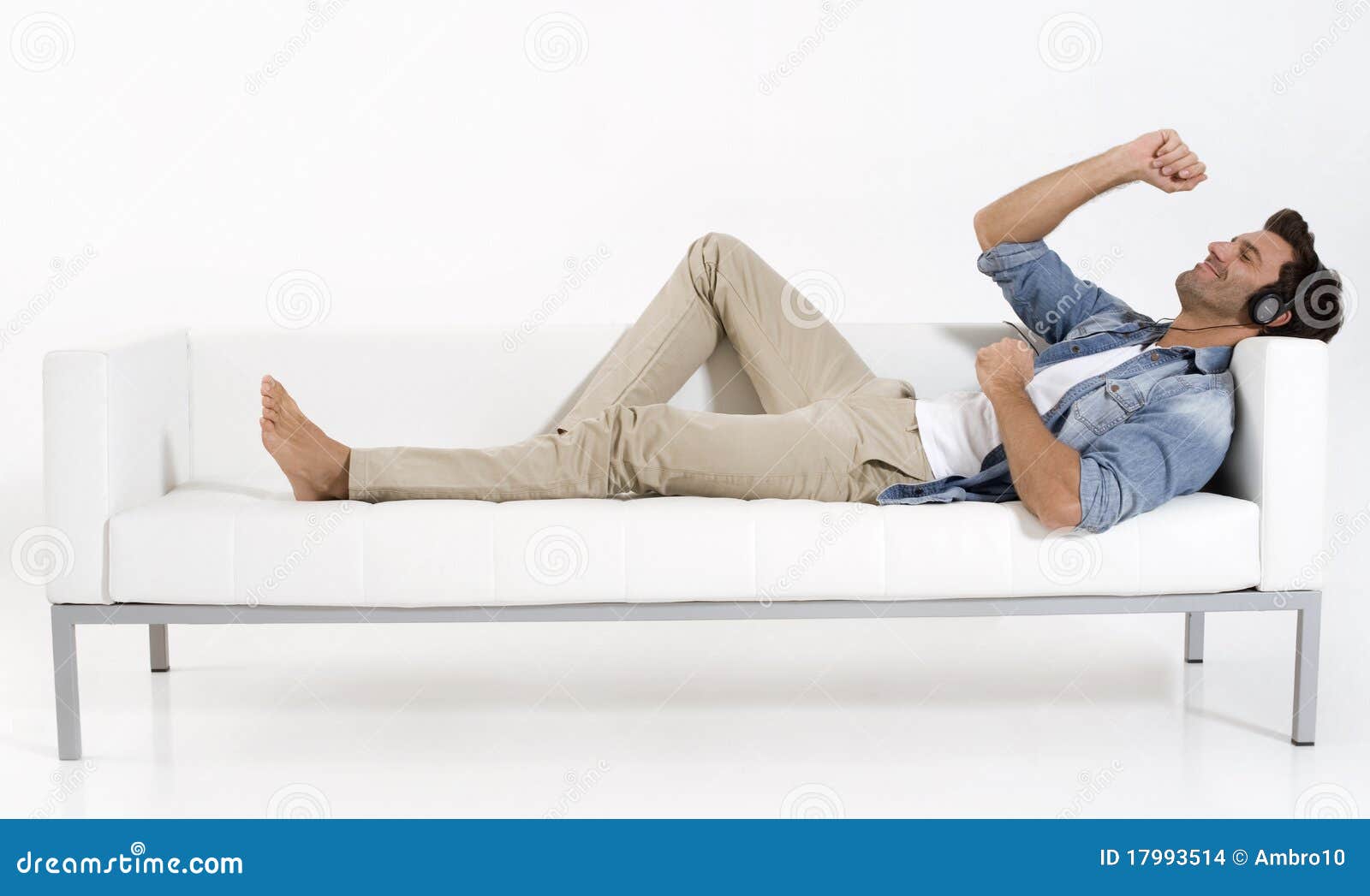 Man on the Couch Listening Music Stock Photo Image of headphones