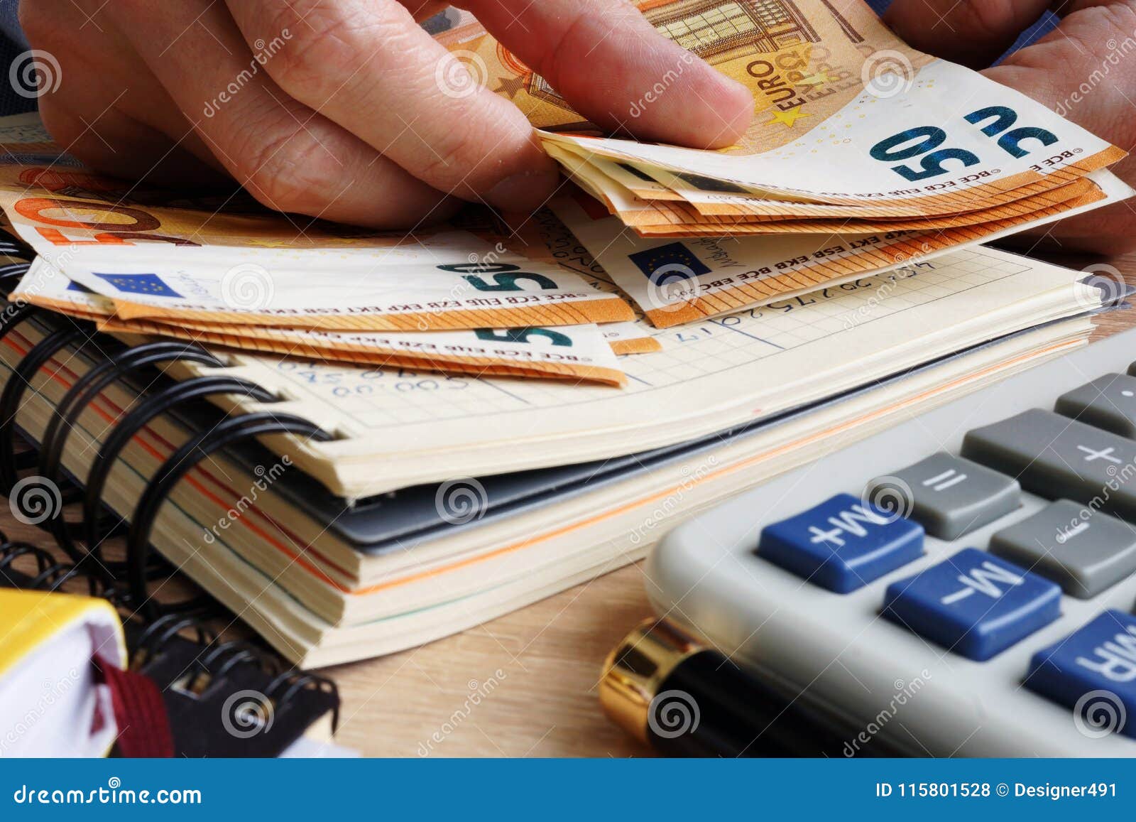man counting euro banknotes. desk with calculator, ledger and euros.