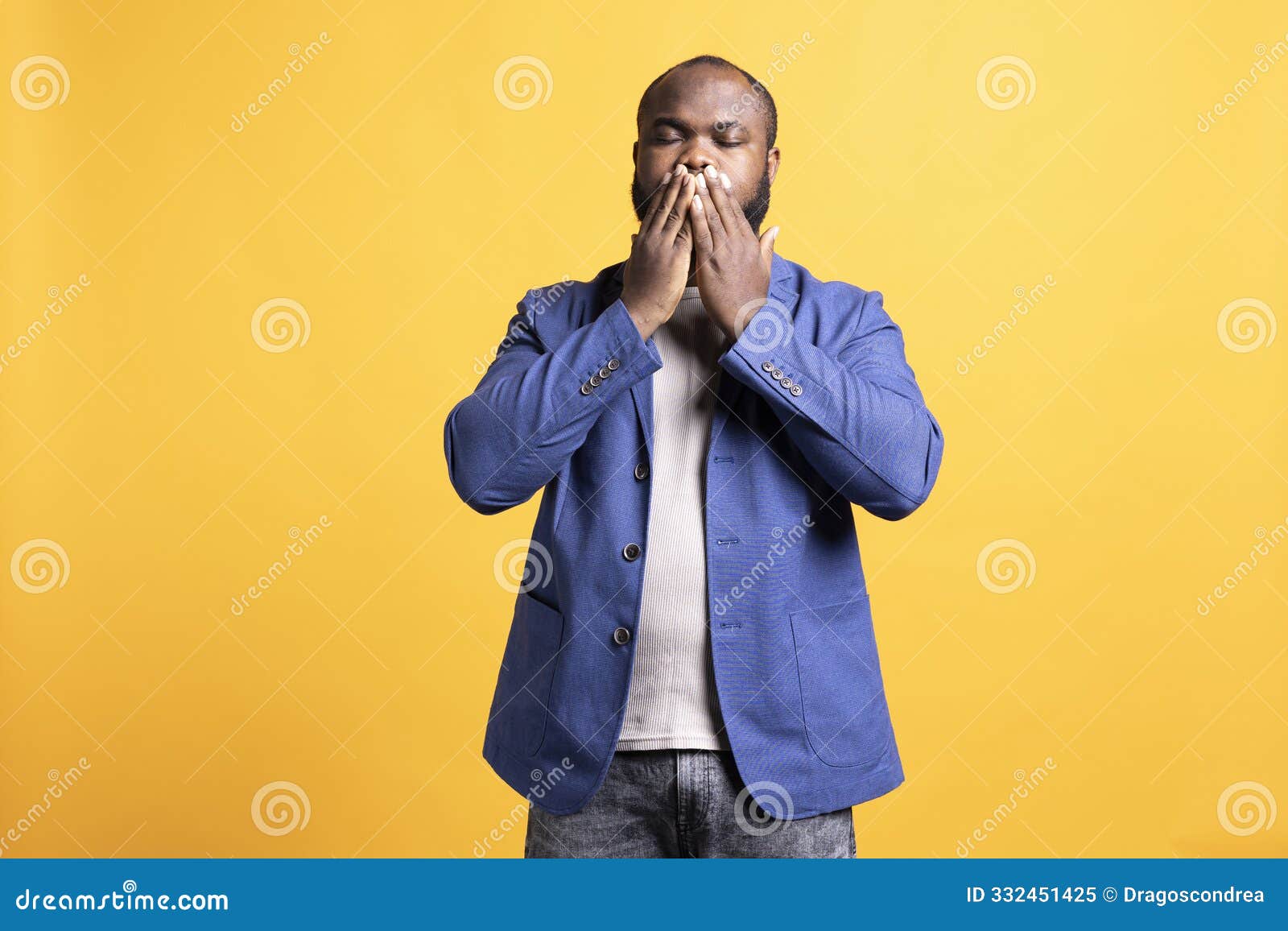 man covering mouth with hands,  over studio background