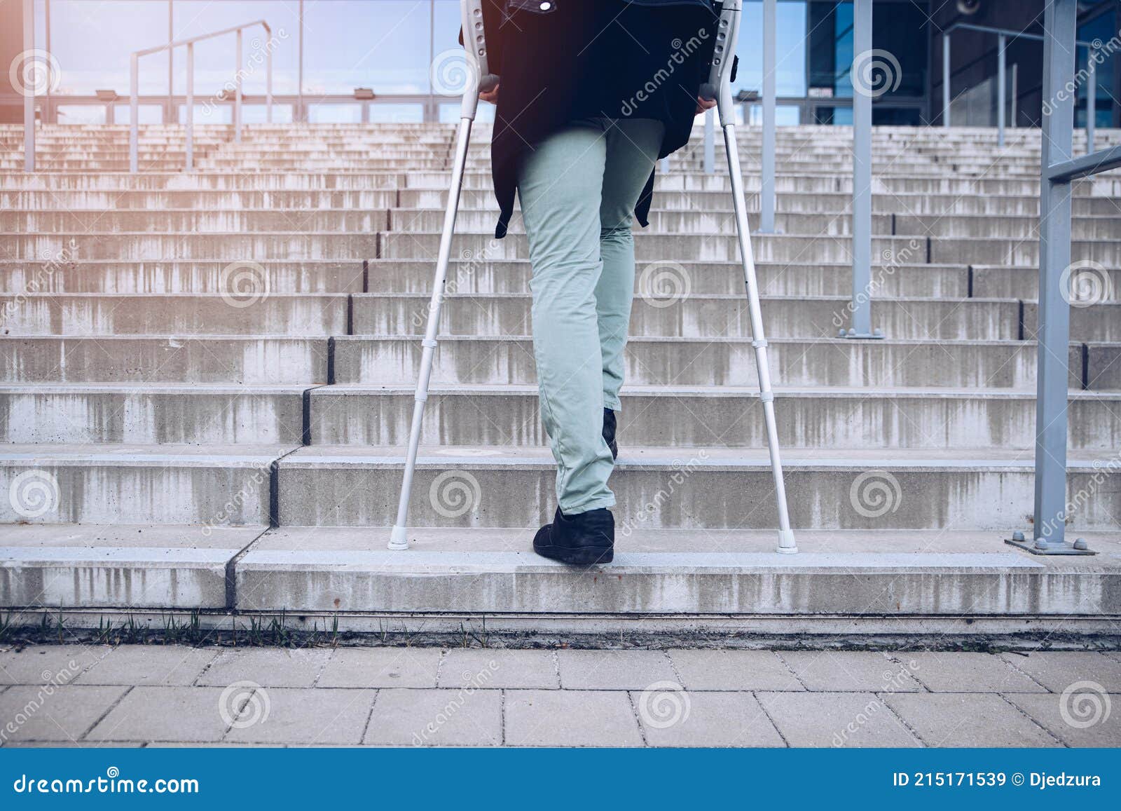 Man on Crutches Climbs a Big Set of Stairs. Stock Image Image of