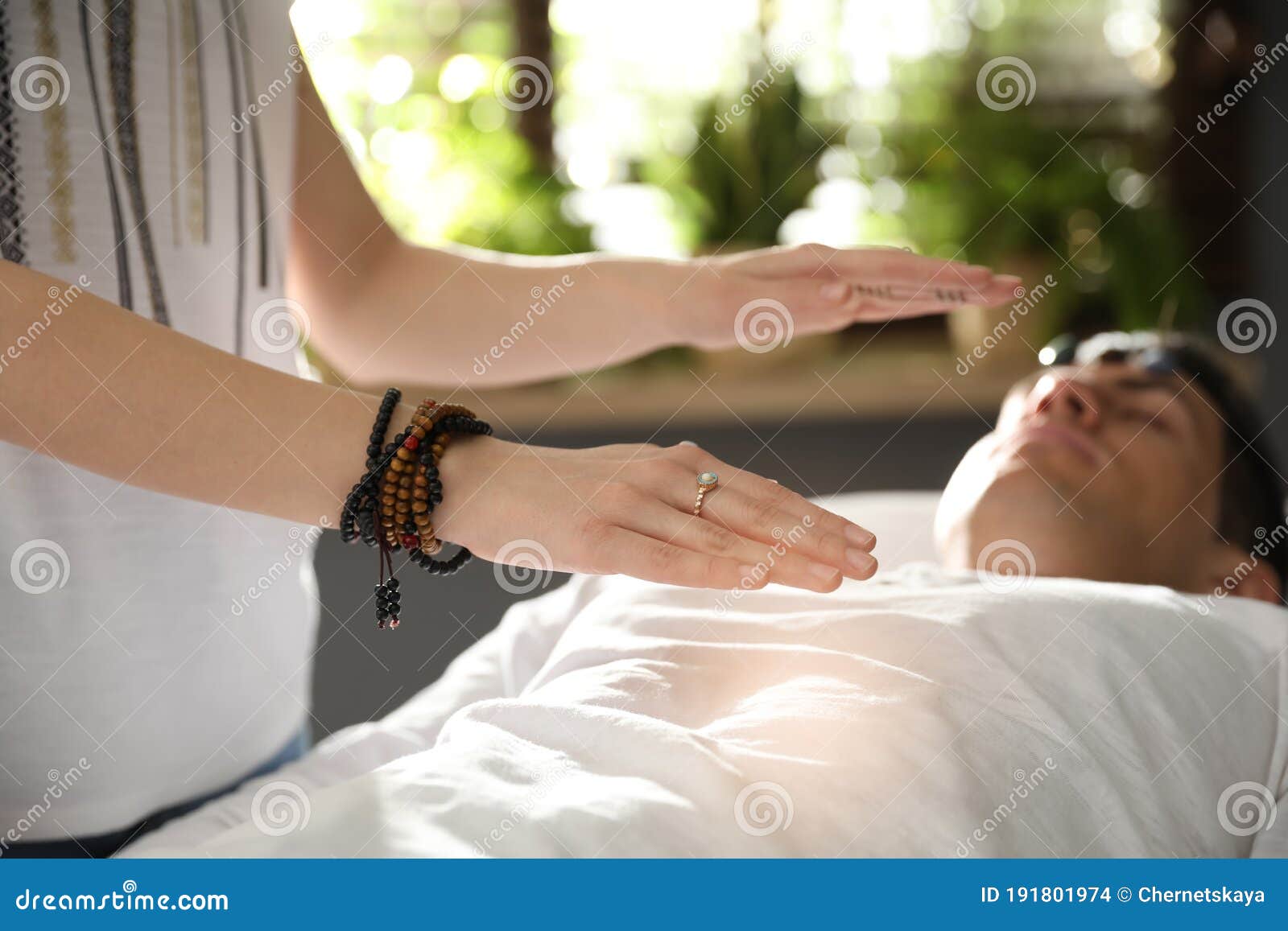 man during crystal healing session in room