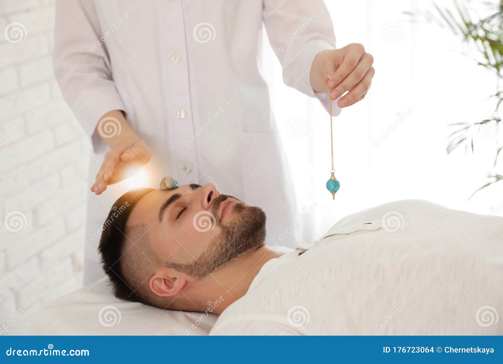 Man during Crystal Healing Session in Therapy Room Stock Photo Image
