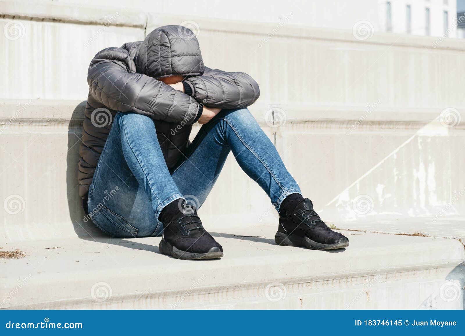 Man Curled Up Sitting on an Outdoor Stairway Stock Image - Image of ...