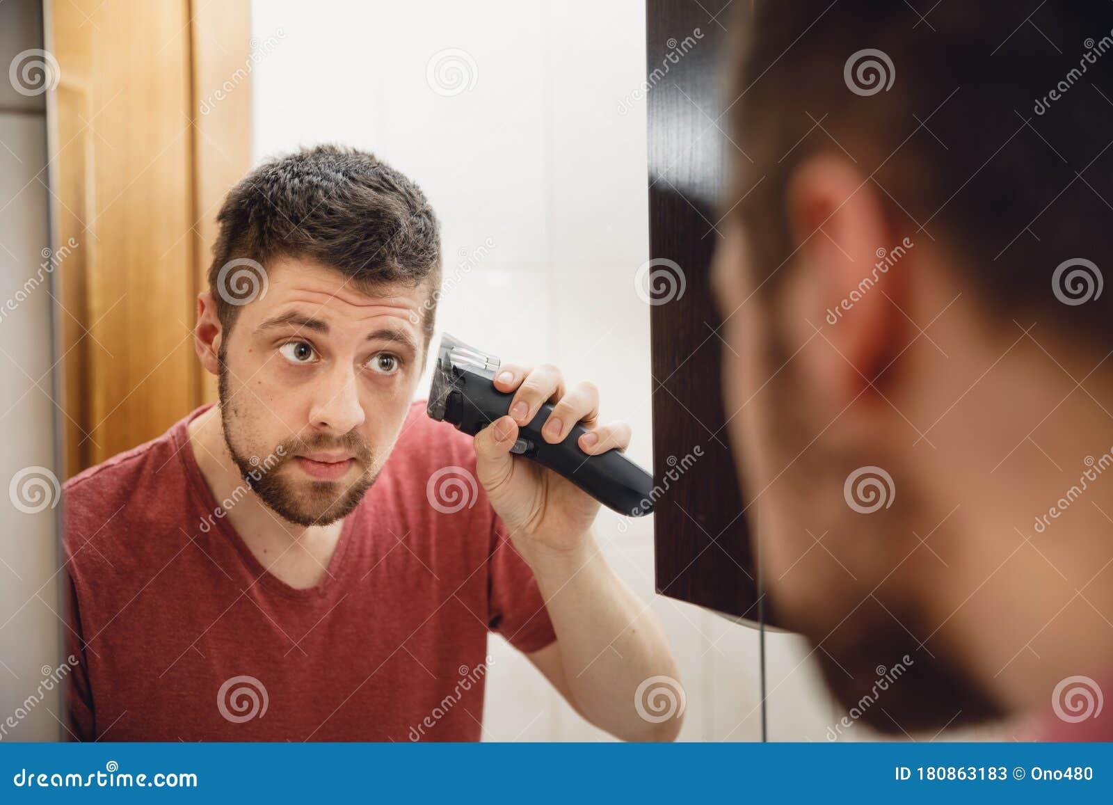 A Man Cuts His Hair on His Head with an Electric Razor Stock Image