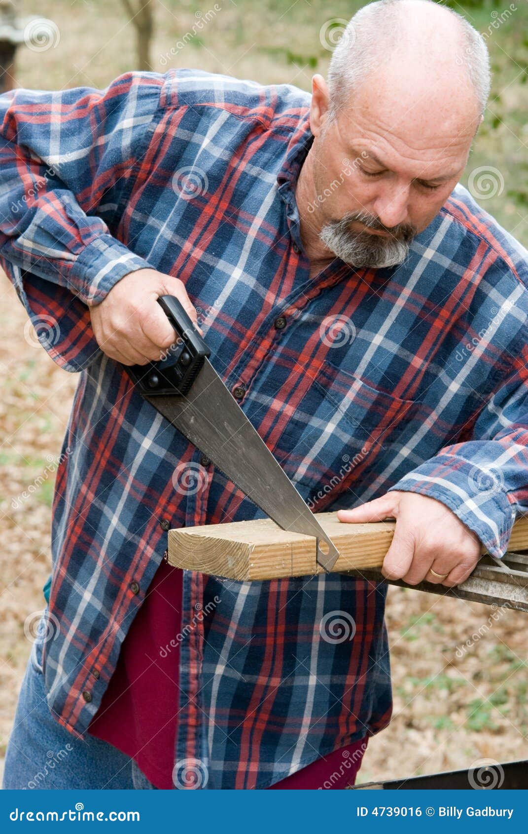 Man Cutting Board with Hand Saw Stock Photo Image of building