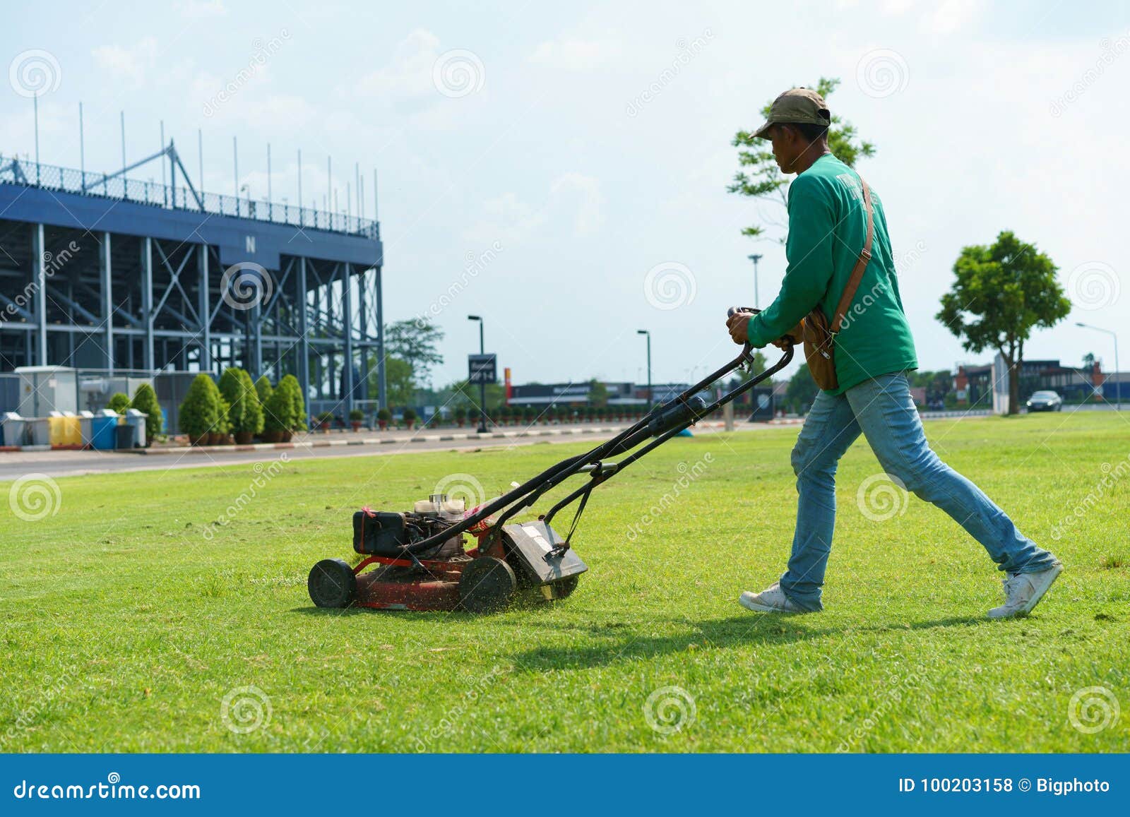 Man Cutting the Grass with Lawn Mower Editorial Stock Photo Image of