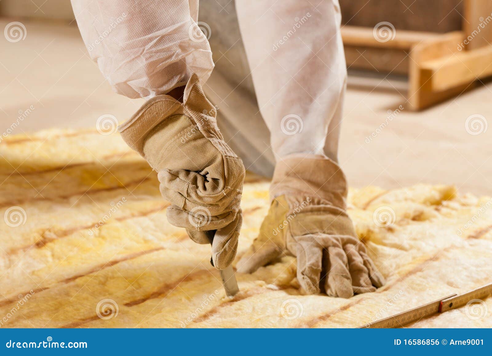 man cutting insulation material for building