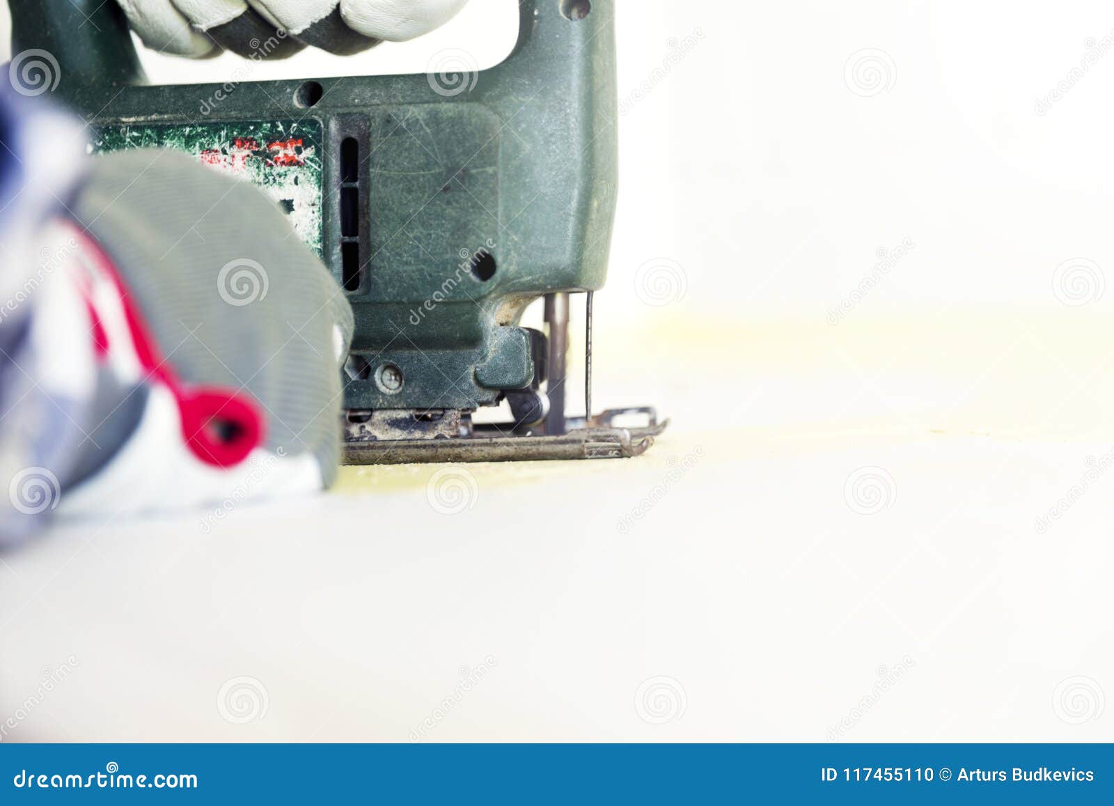 Man Cutting Kitchen Countertop Using Electric Jigsaw Home