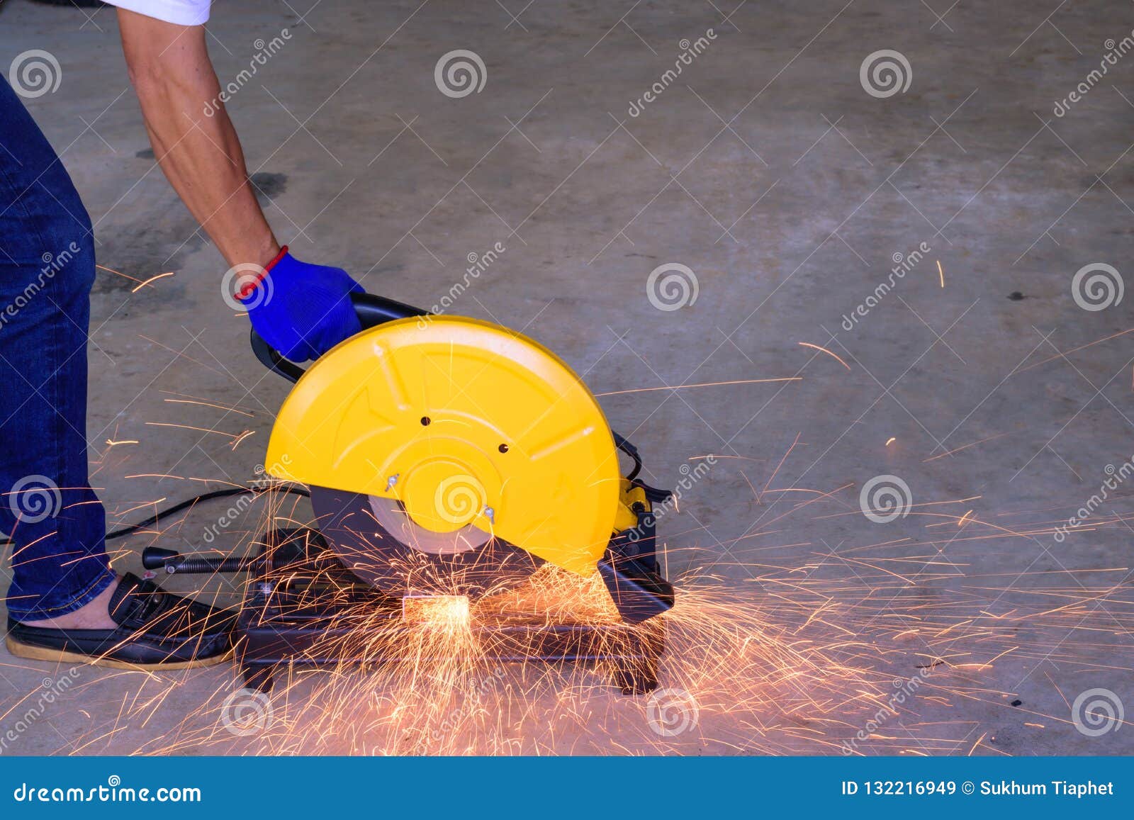 A Man Cutting Steel with a Electric Steel Cutter Machine Stock Image