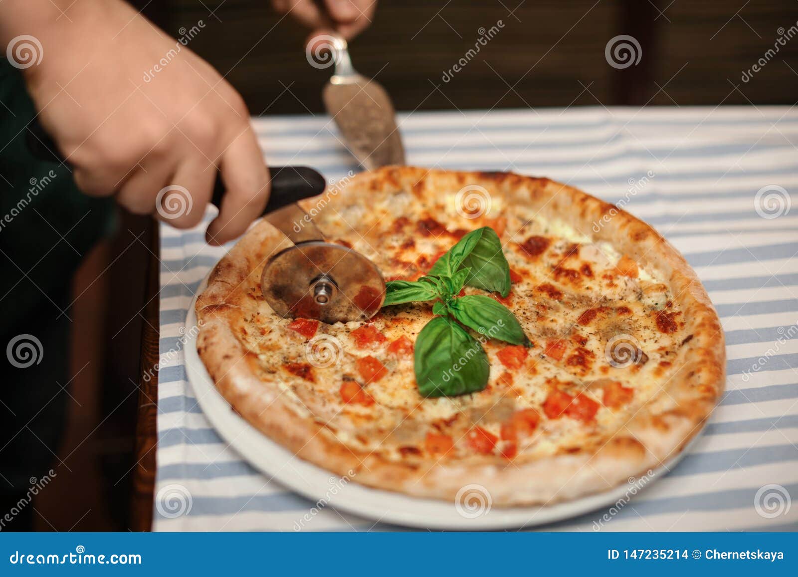 Man Cutting Tasty Oven Baked Pizza on Table Stock Photo - Image of ...
