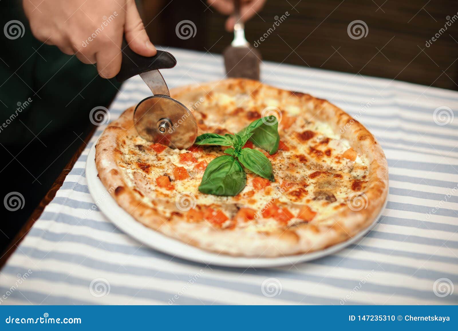 Man Cutting Tasty Oven Baked Pizza on Table Stock Photo - Image of ...