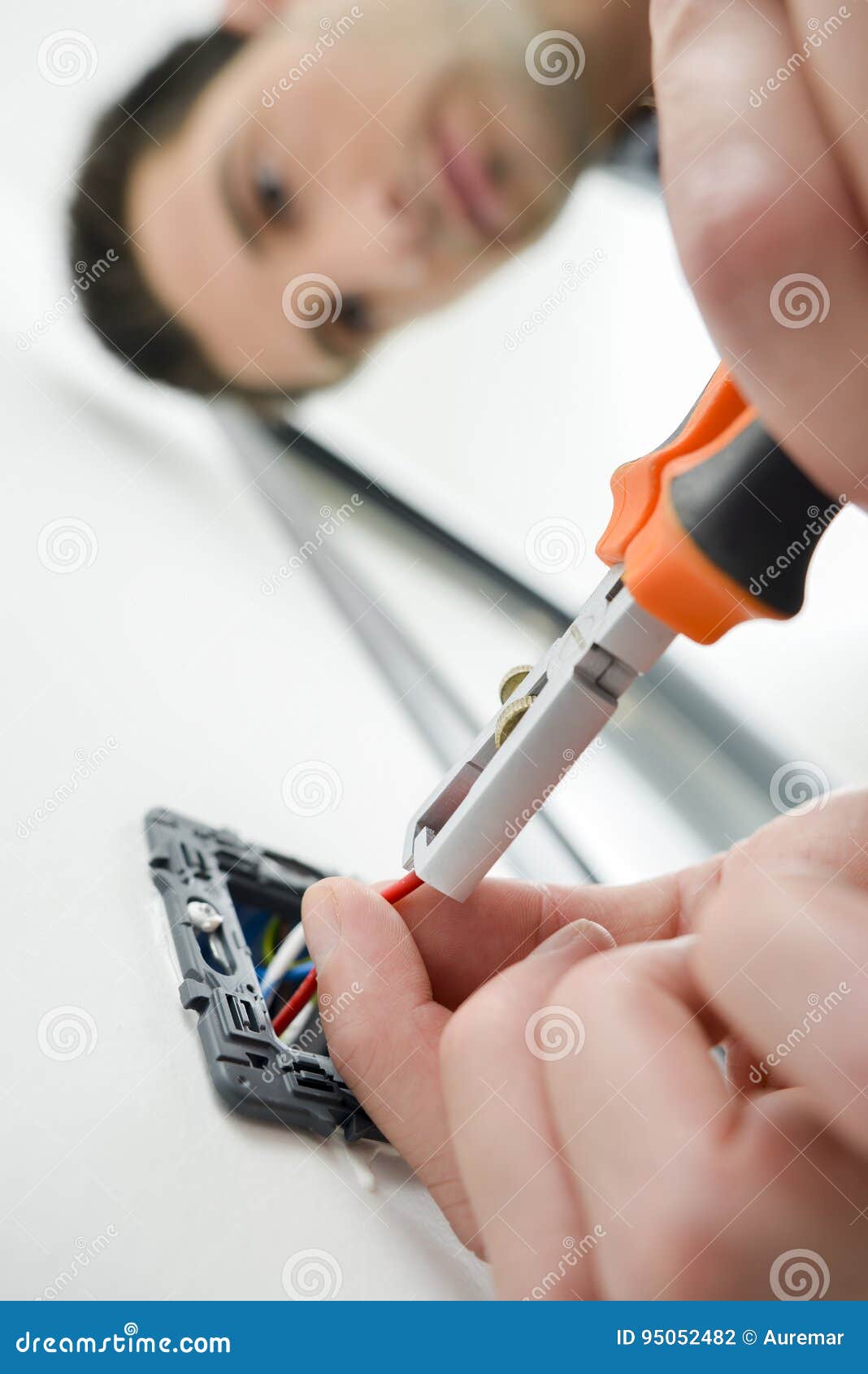 Man cutting wires in plug stock photo. Image of safety 95052482