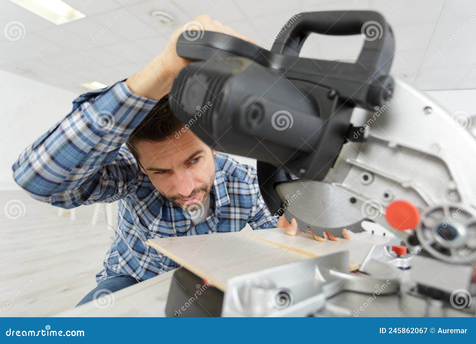 man cutting wood with circular saw