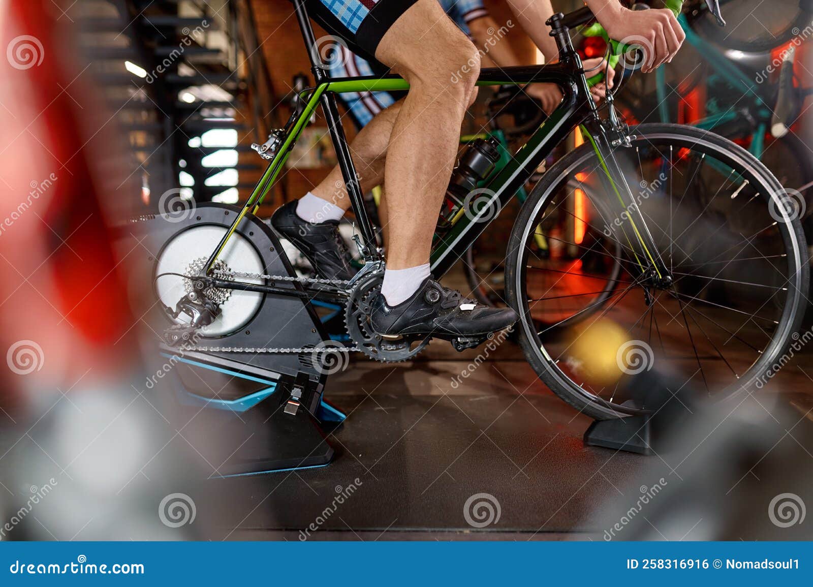 man cycling shot with closeup on leg pedaling