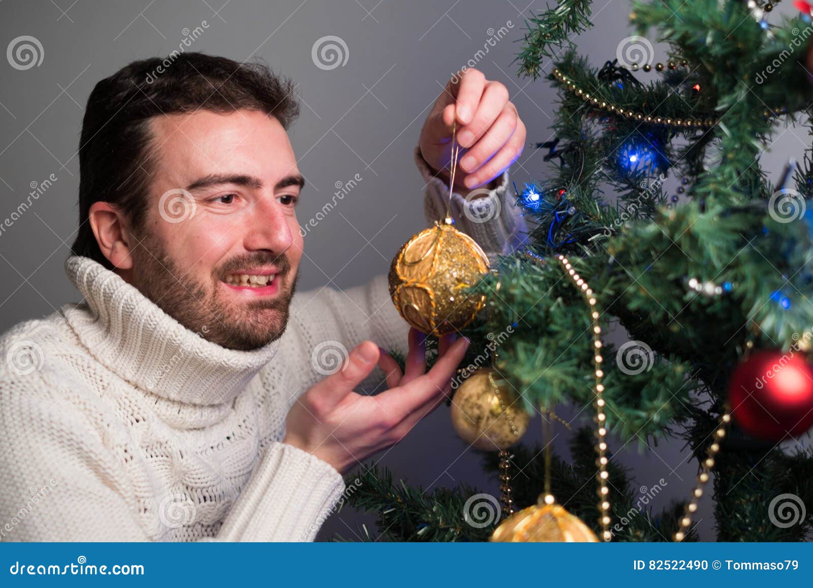 Man Decorating a Christmas Tree with Golden Balls Stock Photo Image of celebration, bauble