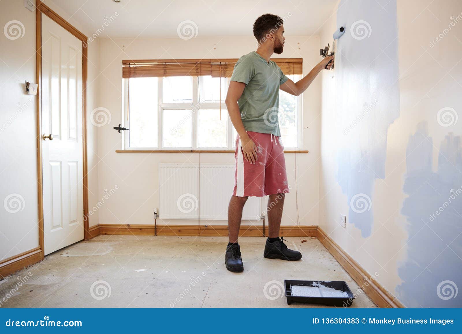 Man Decorating Room in New Home Painting Wall Stock Image - Image ...