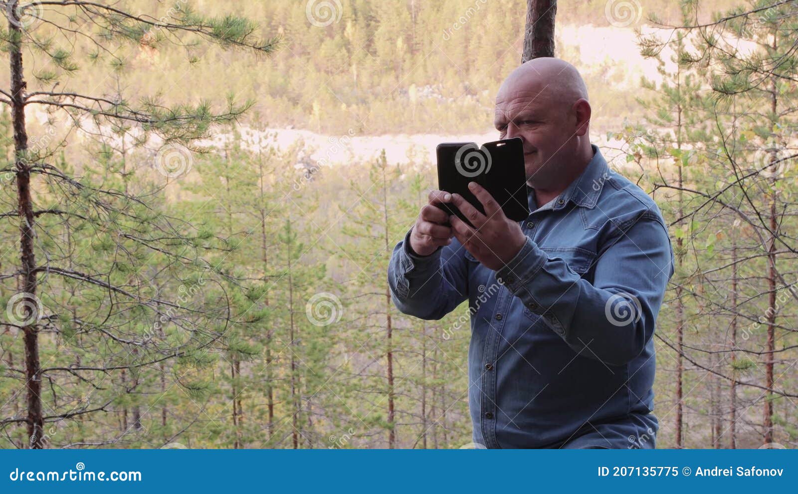 A Man in a Denim Shirt Takes Pictures of Himself on the Edge of a Quarry  Stock Video - Video of summer, internet: 207135775