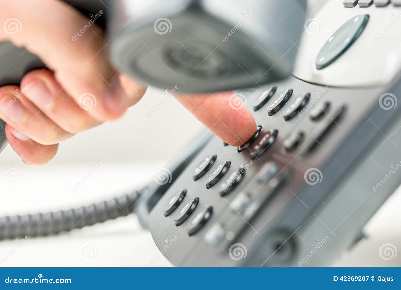 man dialling out on a telephone