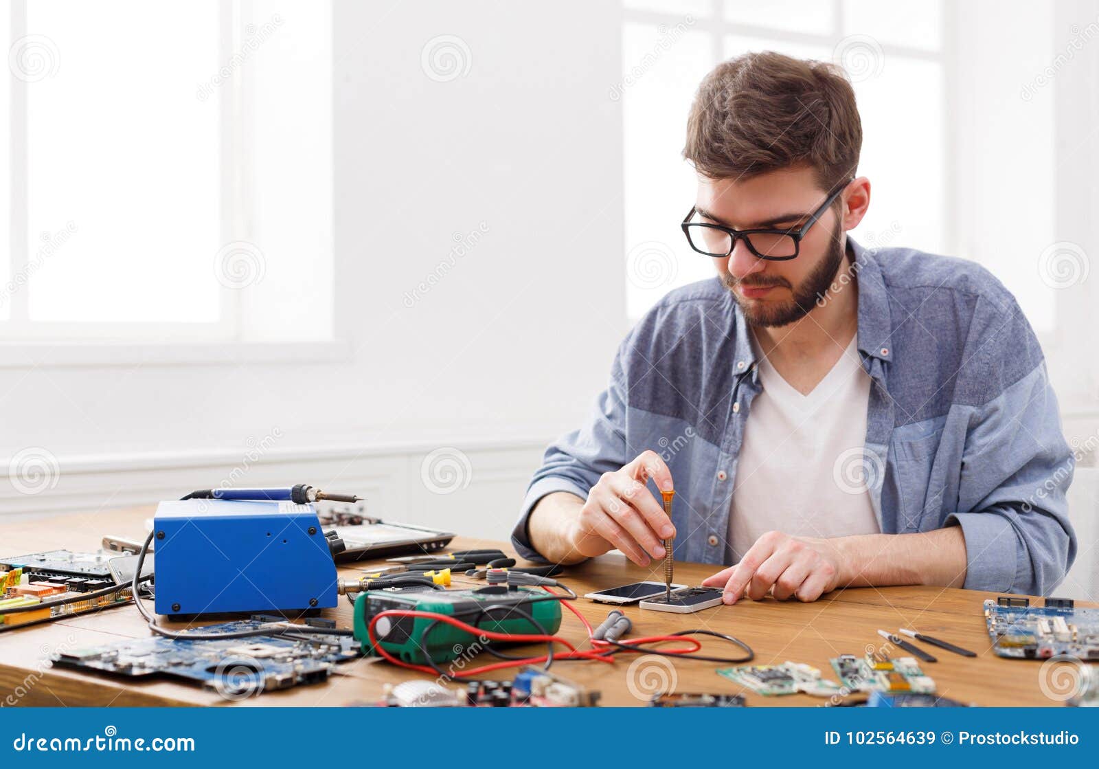 Disassembled phone in repair service. frustrated man holding a smart phone  in hands. akku, batterie, kaputt on Craiyon