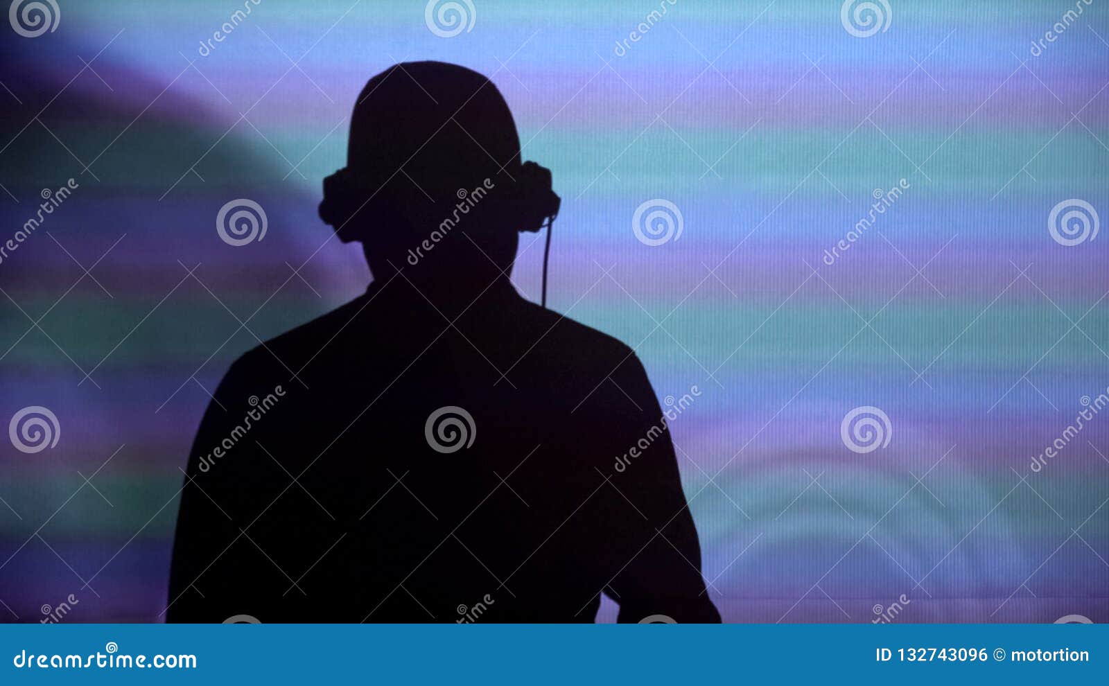 man dj silhouette on wall, performing for party, dancing to music, back view