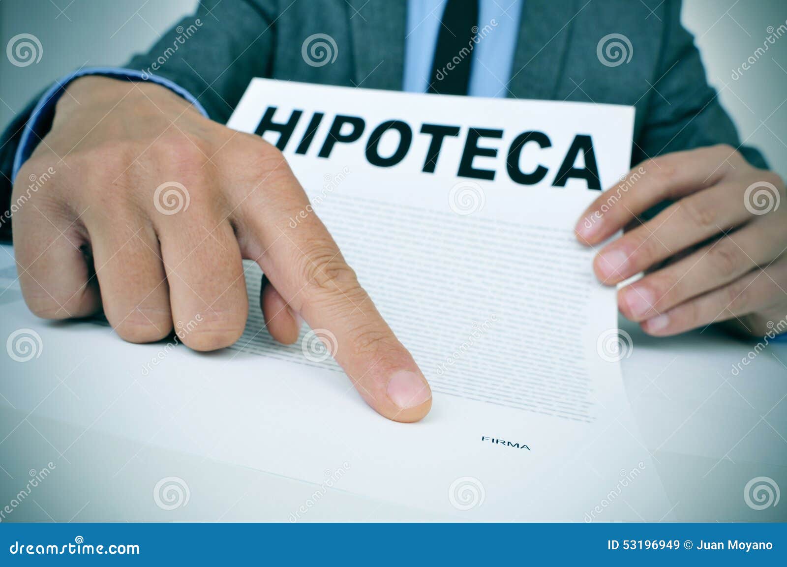 man with a document with the word hipoteca, mortgage loan contra