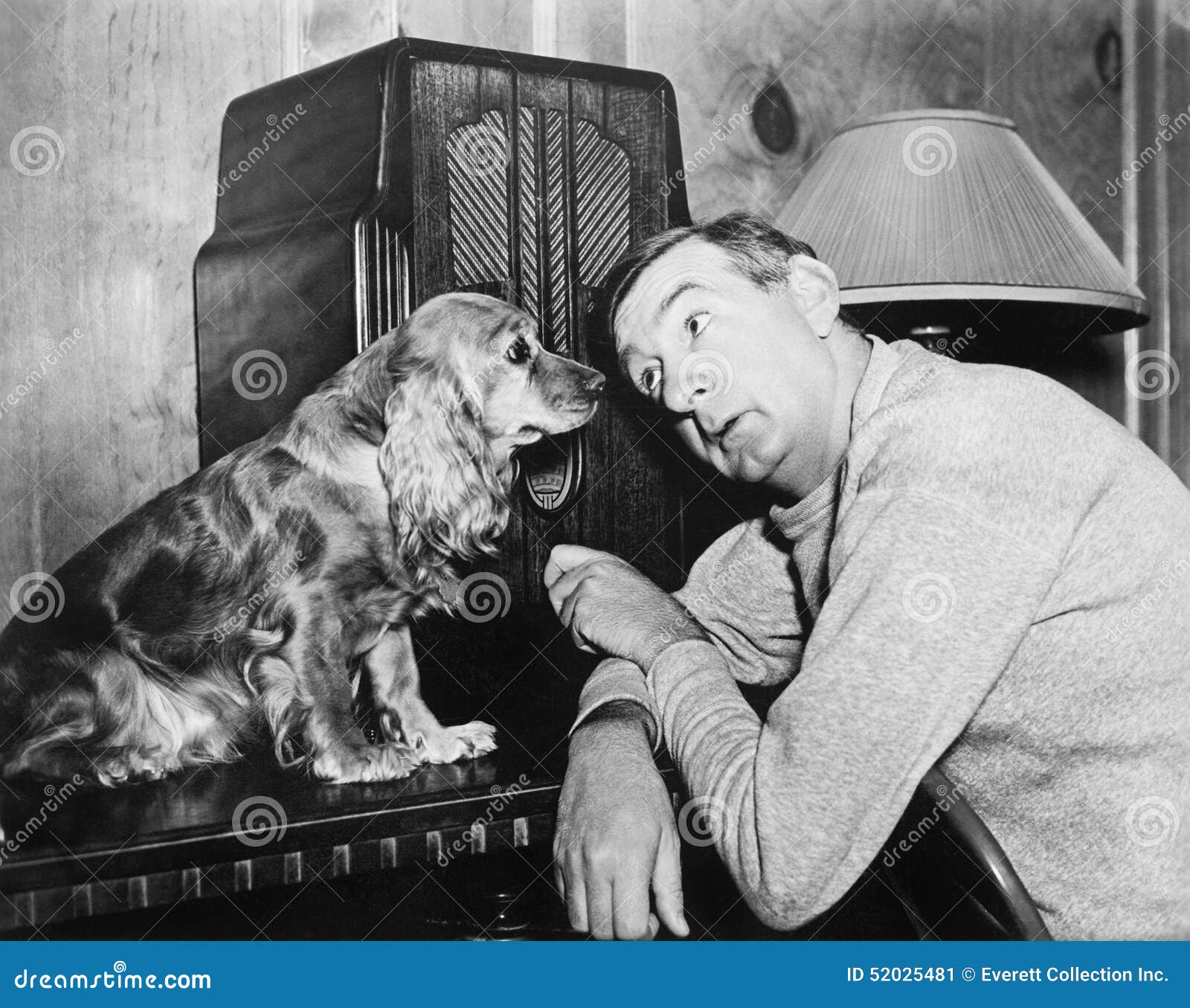 man and dog listening to the radio