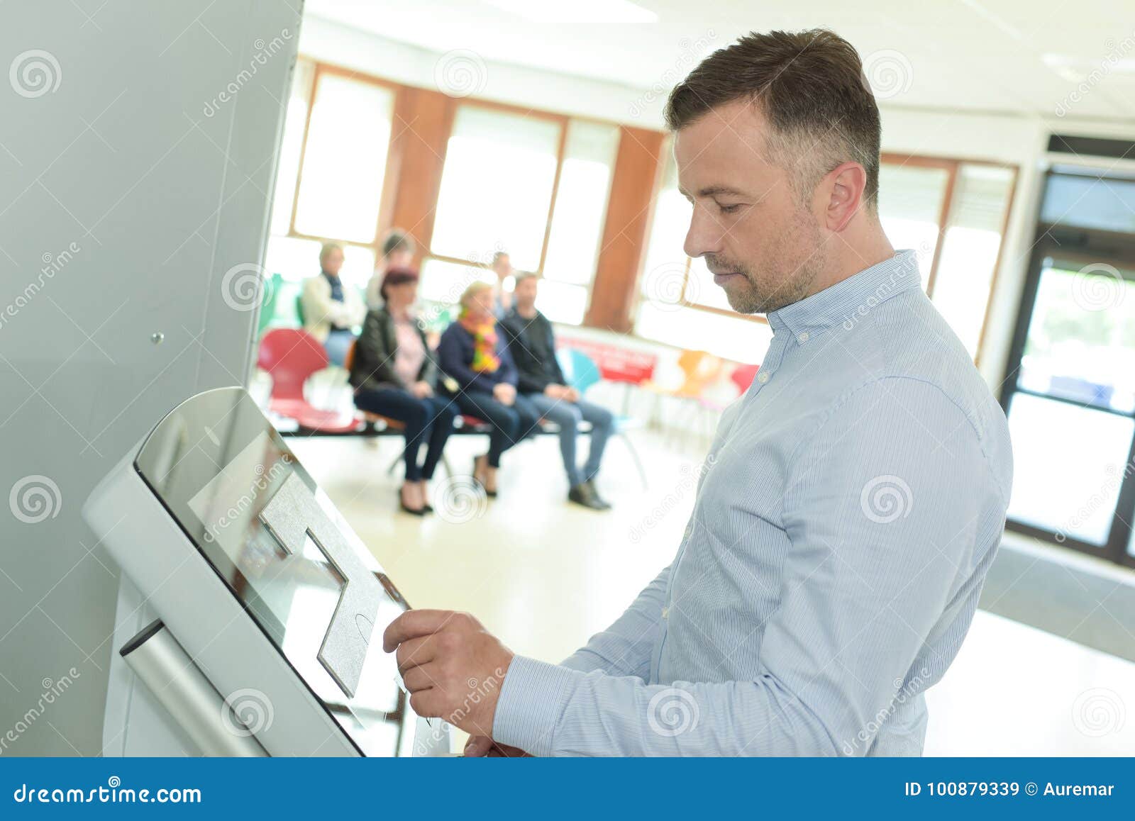 Man Doing Check In At Self Help Desk In Airport Stock Image