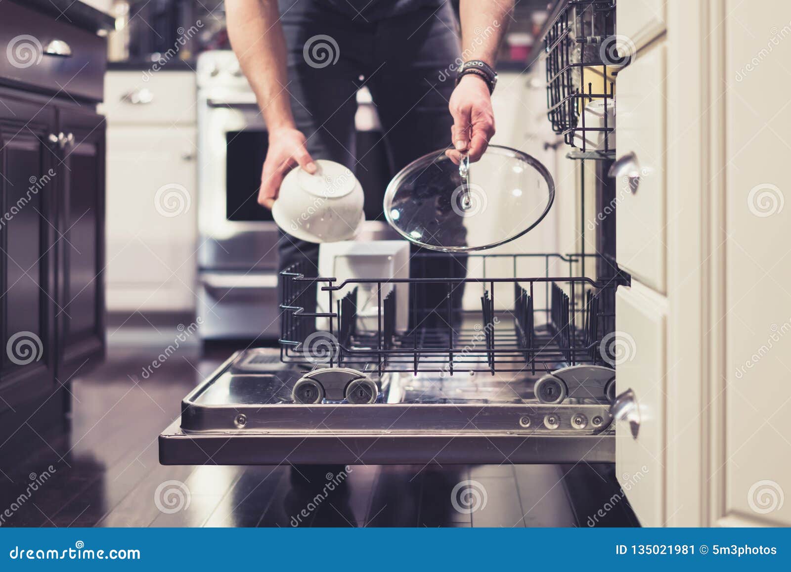 man doing dishes cleaning in the kitchen household chores