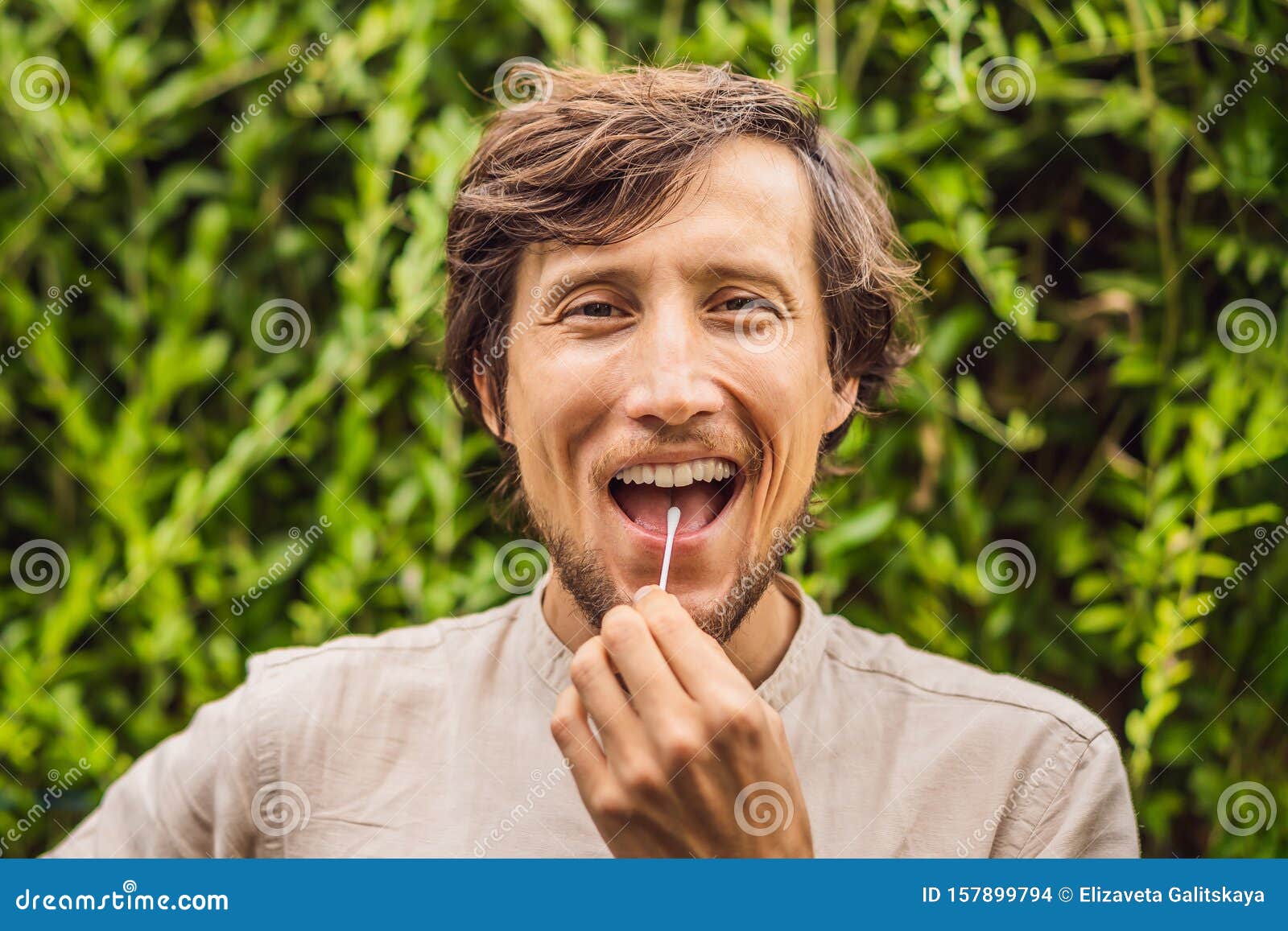 Man Doing DNA Test with Cotton Swab. Test for Home Use Stock Photo