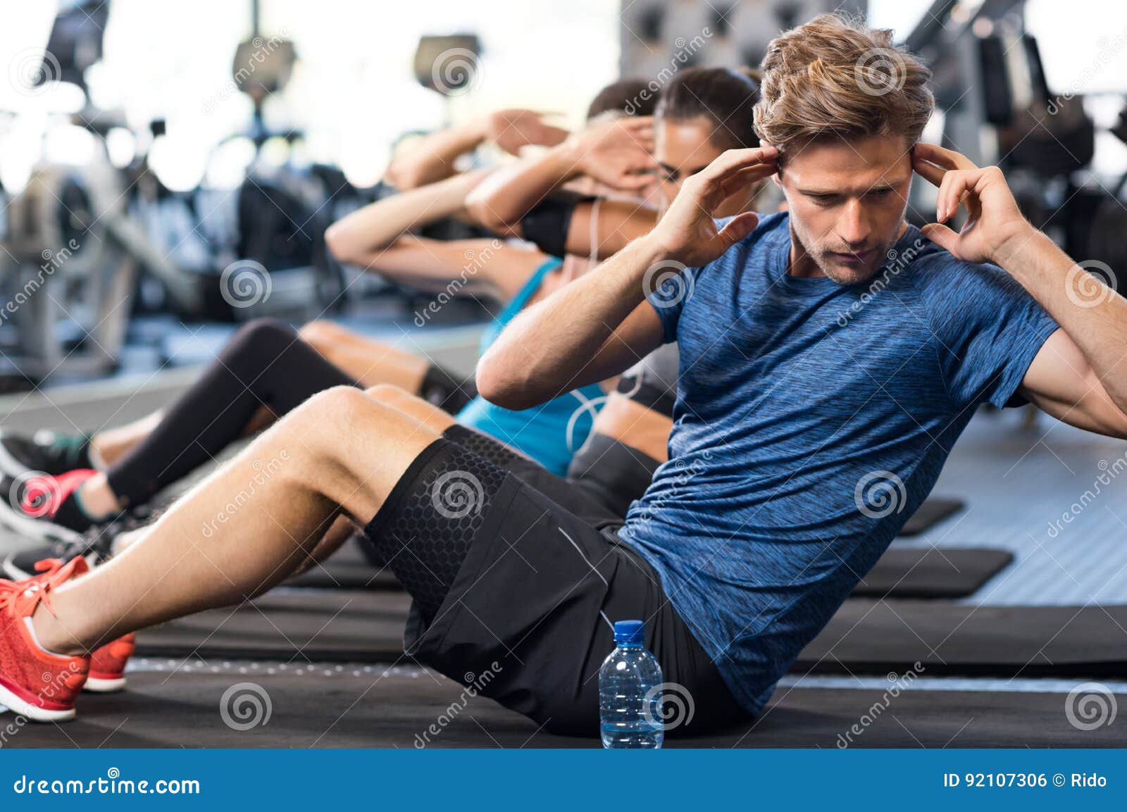 https://thumbs.dreamstime.com/z/man-doing-sit-ups-muscular-guy-gym-other-people-background-young-athlete-stomach-workout-modern-gym-handsome-fit-92107306.jpg