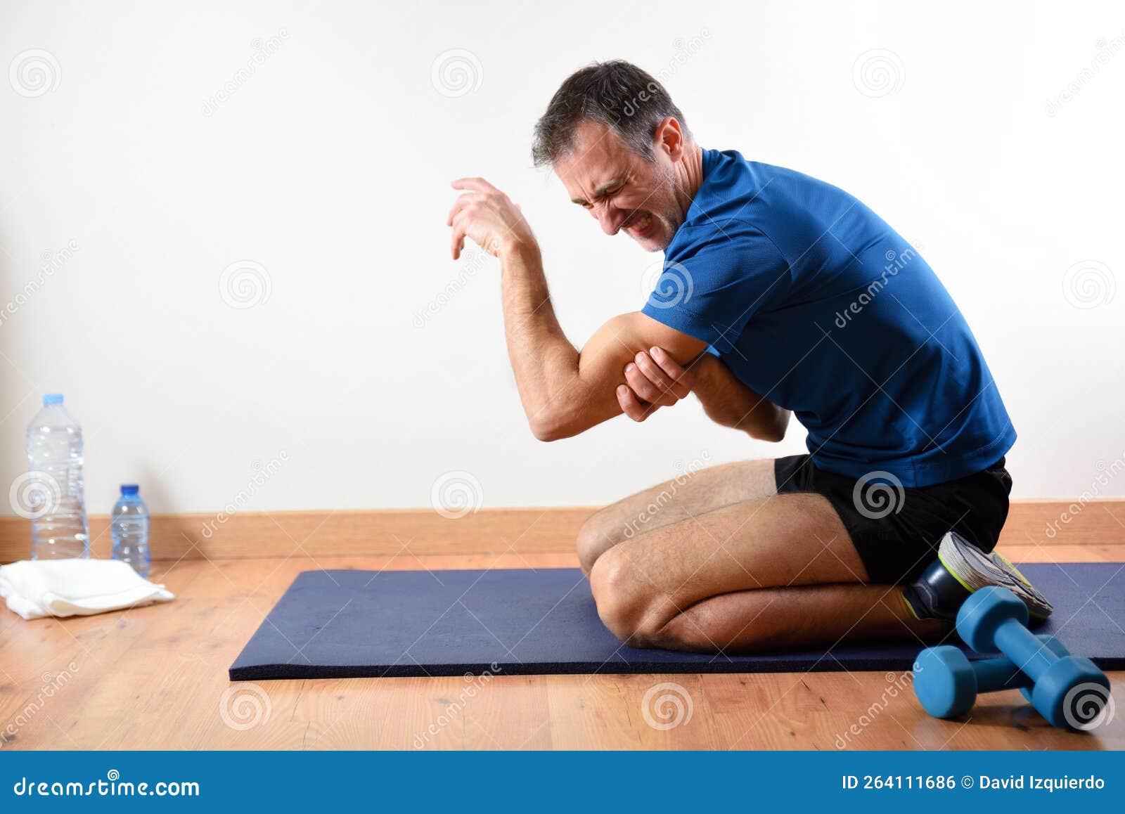 man doing sport indoors complaining with triceps pain