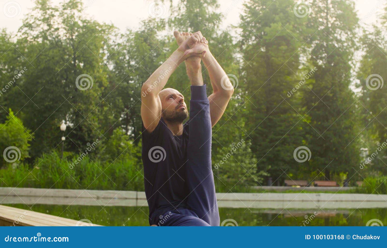 A Man Doing Yoga Exercises in the Park Stock Photo - Image of exercises ...