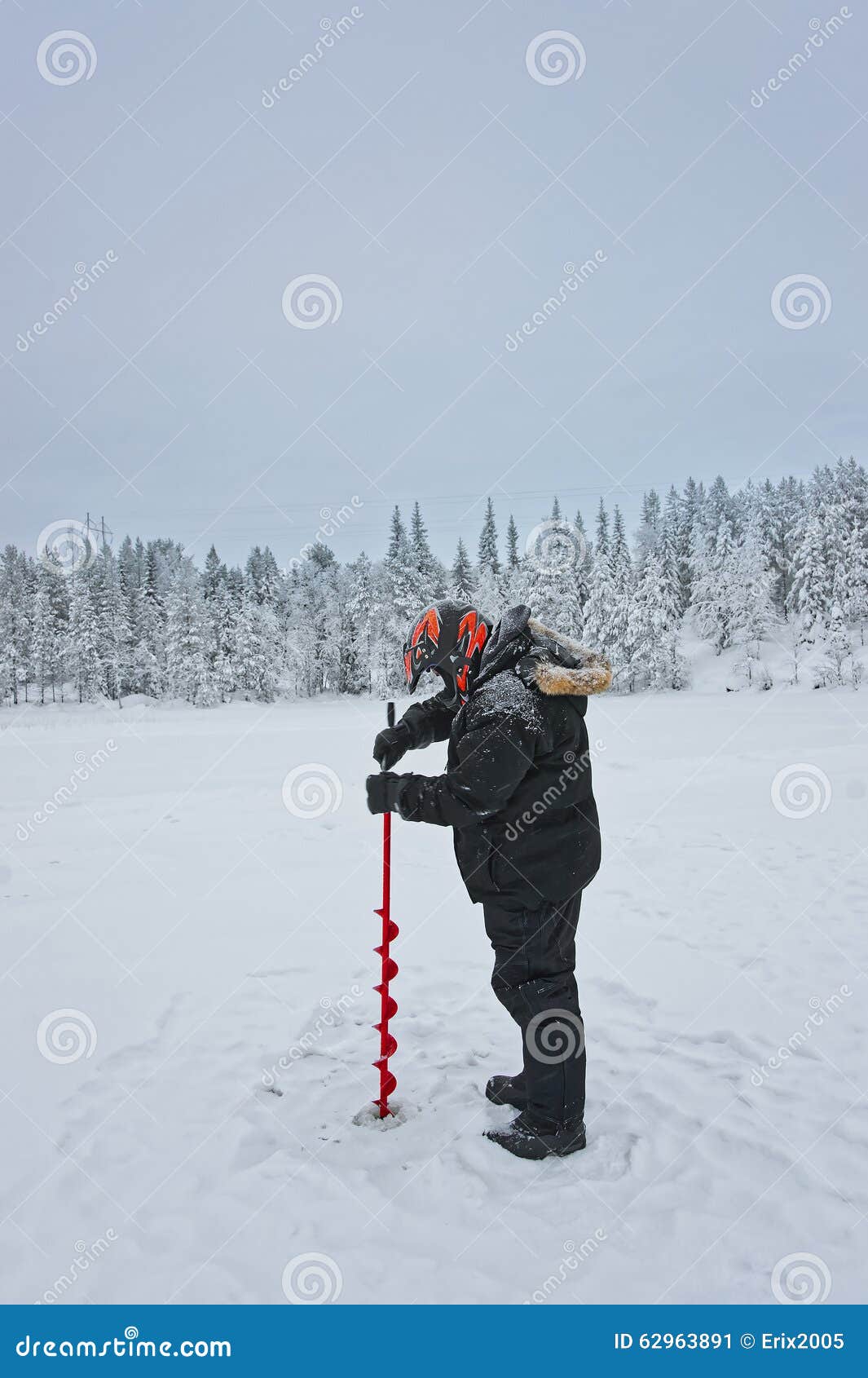 Download Man Is Drilling Ice-hole For Ice-fishing In Ruka In ...
