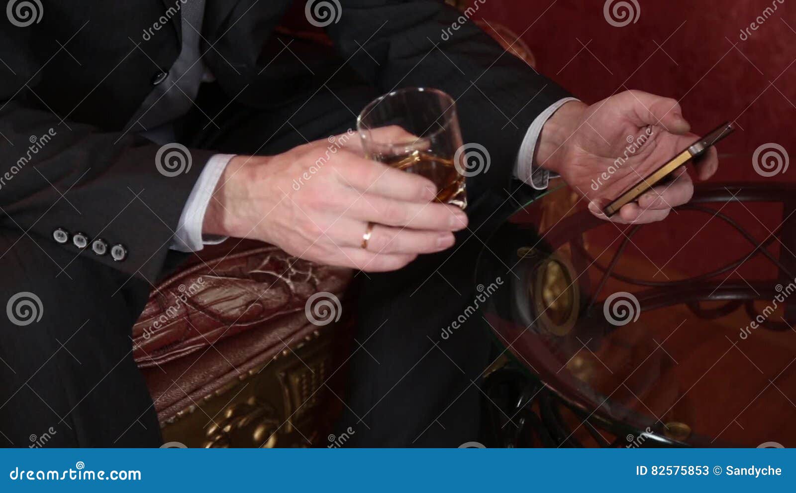 Man Drinking Brandy, Puts the Glass on the Coffee Table and Irritably