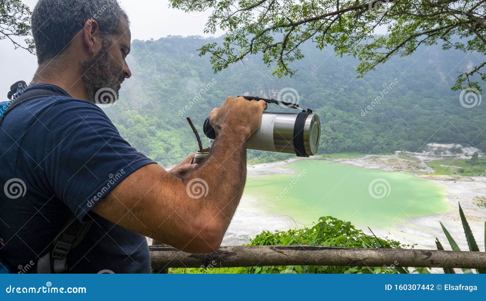 man drinking mate at laguna de alegria at the tecapa volcano, el salvador