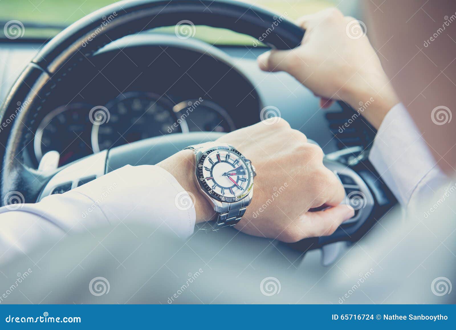 Man Driving a Car and Looking at Watch Stock Photo Image of late