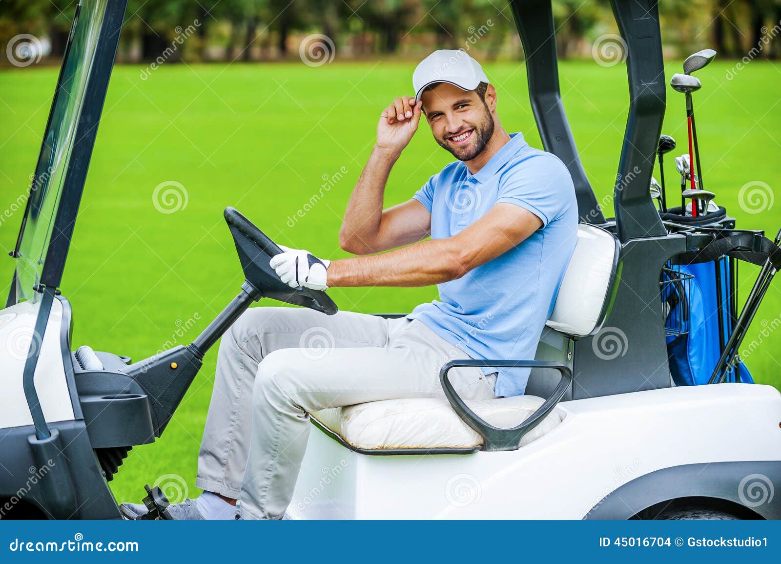 Man driving golf cart. stock photo. Image of grass, male 45016704