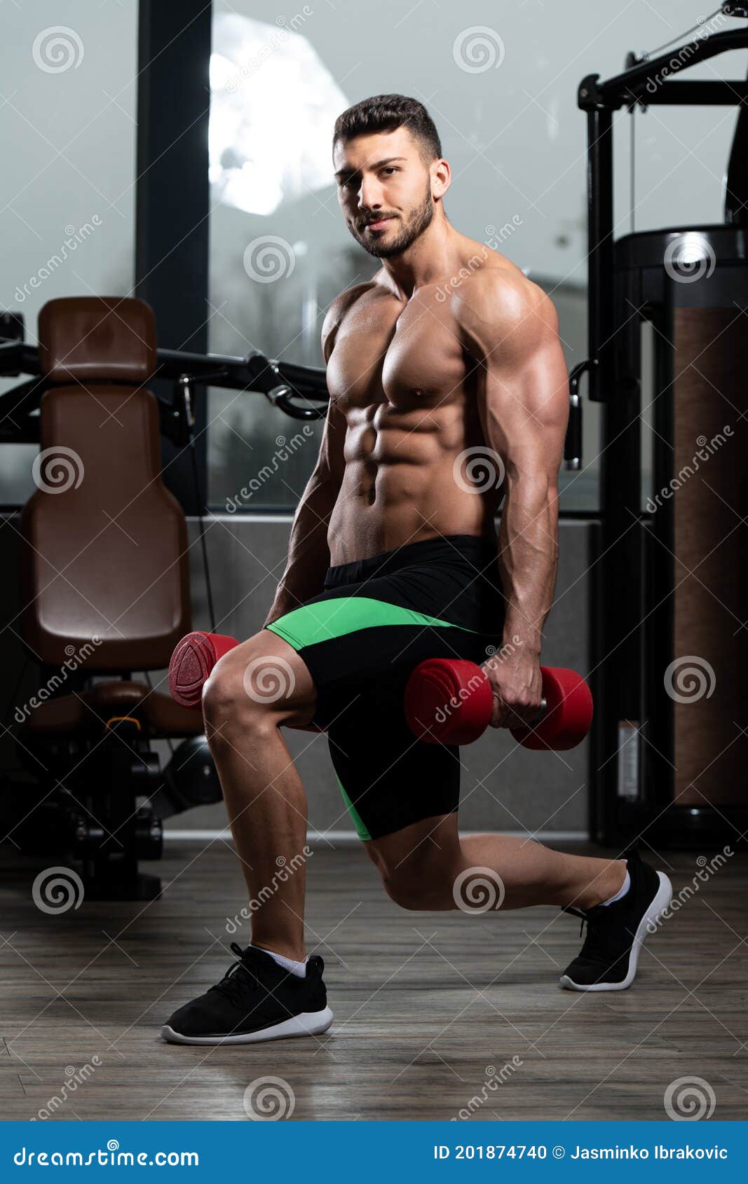 Man With Dumbbells Exercising Quadriceps And Glutes Stock Photo Image man-with-dumbbells-exercising-quadriceps-and-glutes-stock-photo-image