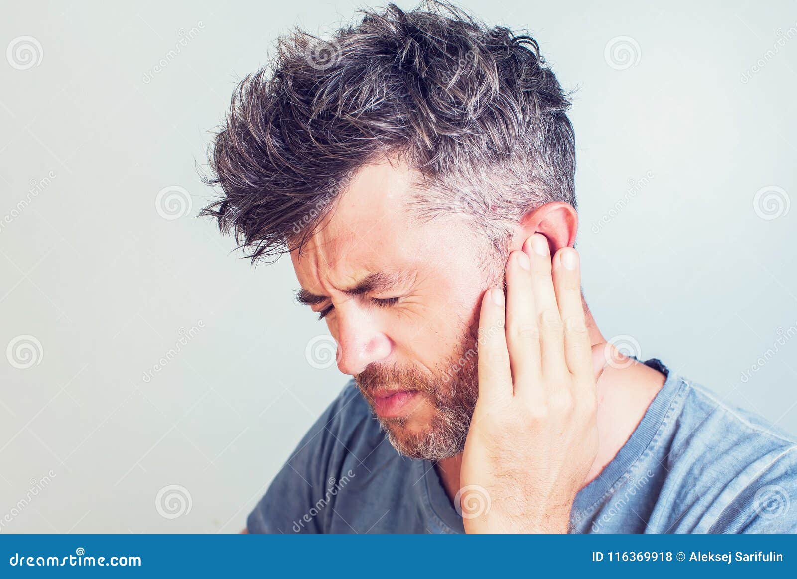 man with earache is holding his aching ear body pain concept