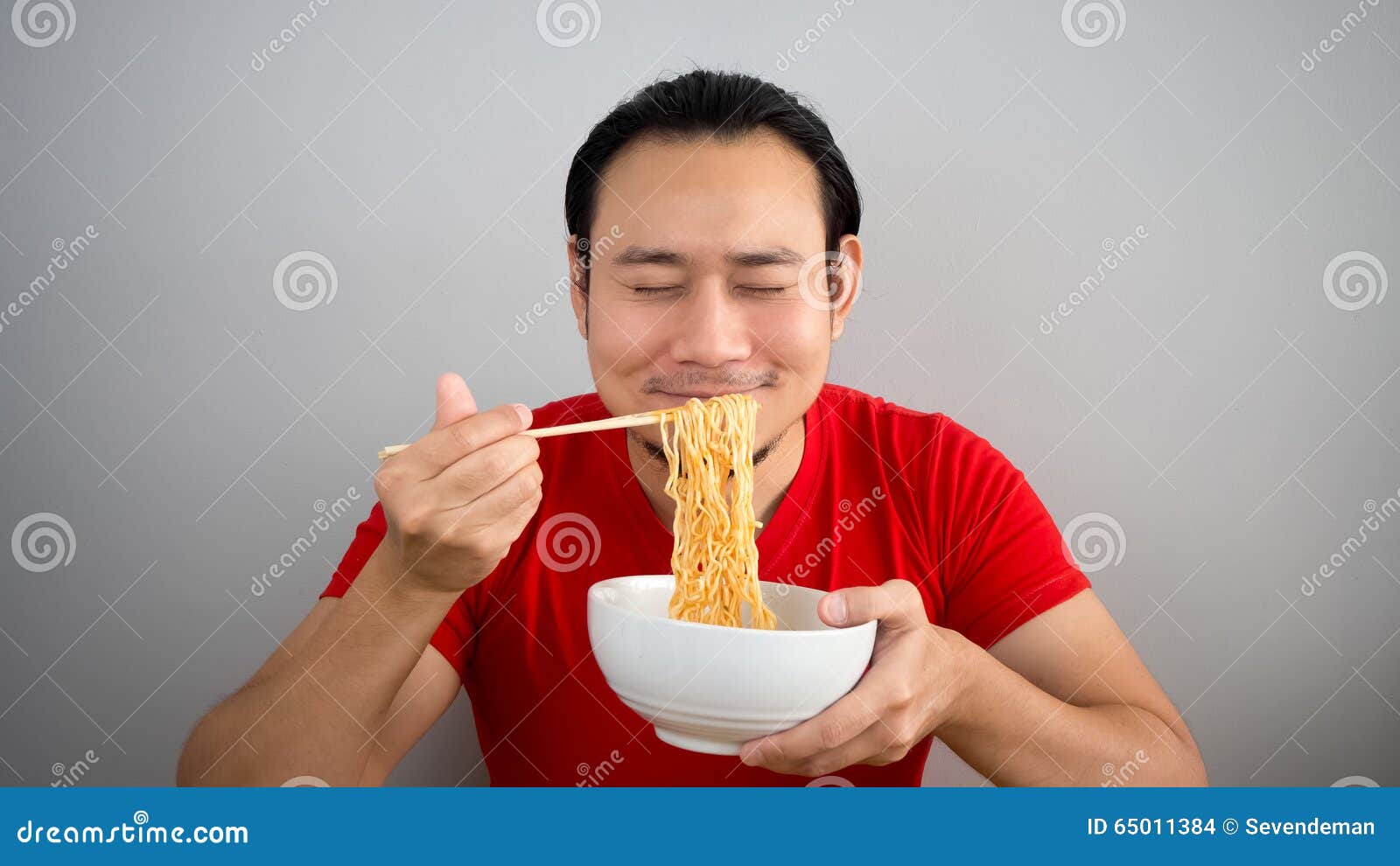 man eating instant noodles.