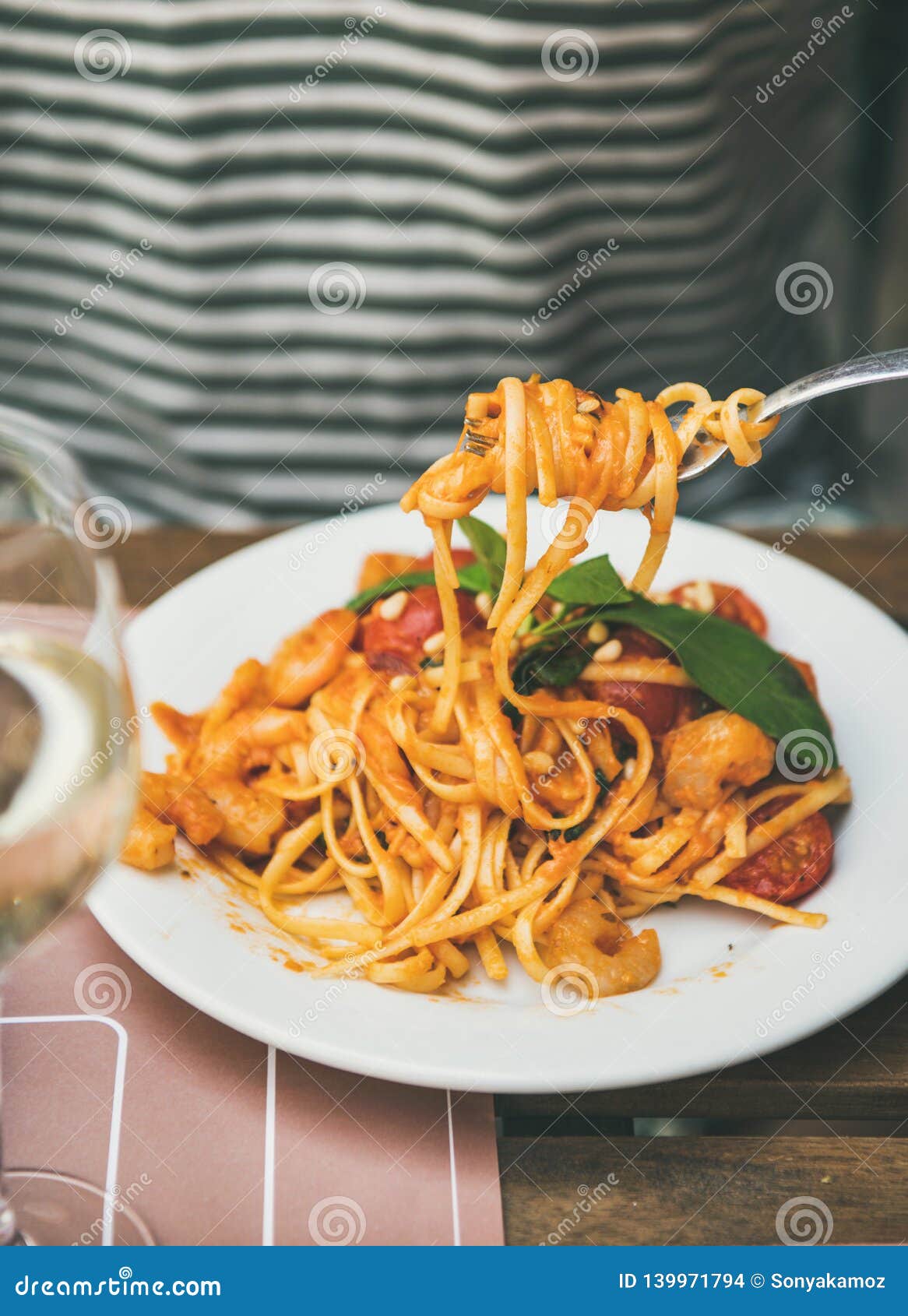 man eating italian spaghetti pasta with fork