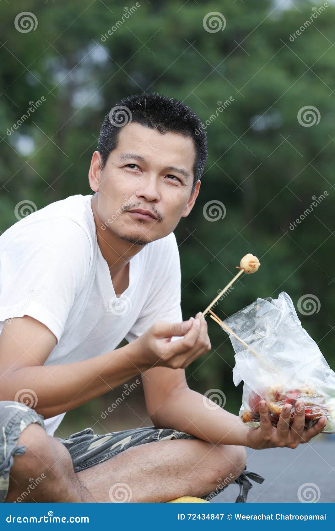 A man eating meatball stock image. Image of person, nature 72434847