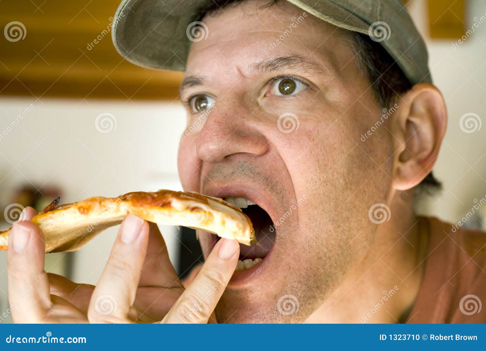 Man Eating Pepperoni Pizza stock photo. Image of hungry 1323710