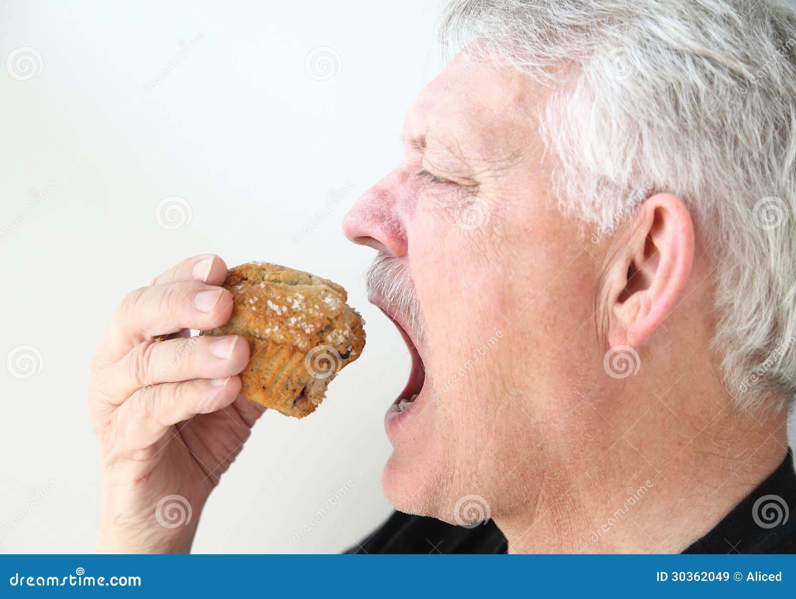 Man eats blueberry muffin stock image. Image of snack 30362049