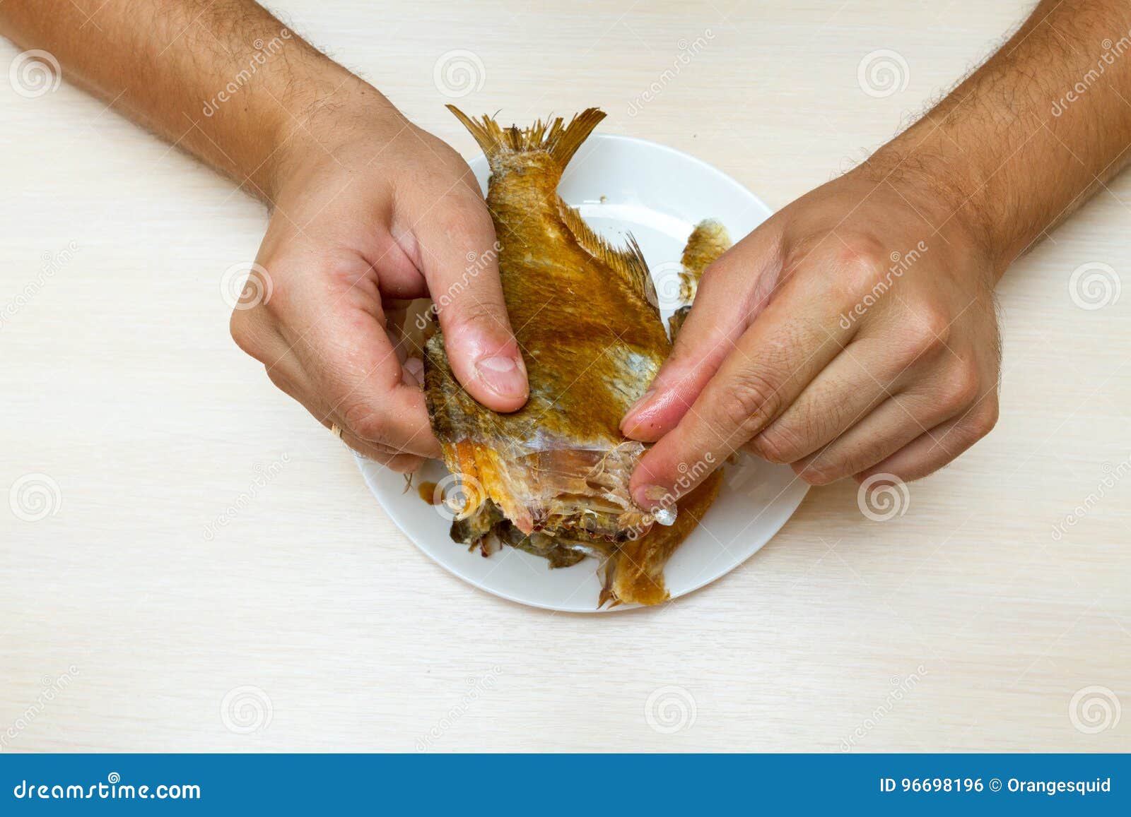 The man eats dried fish. stock photo. Image of treat 96698196